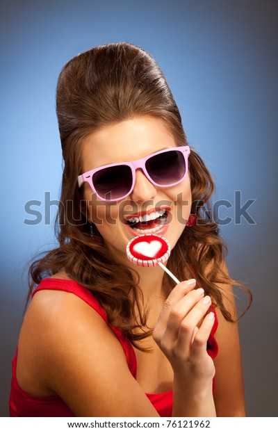 Laughing woman with\
lollipop and pink\
glasses