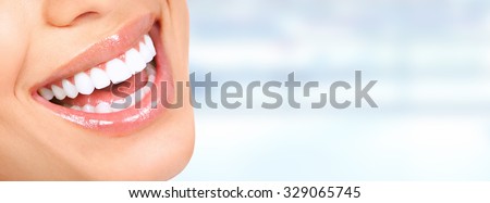 Laughing woman mouth with great teeth over blue background.