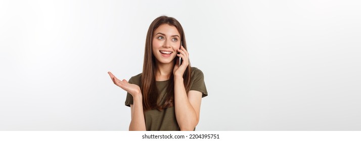 Laughing woman talking and texting on the phone isolated on a white background. - Shutterstock ID 2204395751