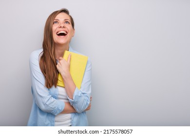 Laughing Woman Teacher Or Student With Open Mouth Holding Book Or Workbook And Looking Up Isolated Portrait  