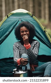 Laughing Young African American Woman Eating A Meal During A Camping Trip With Friends In A Forest