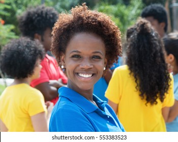 Laughing Young African American Woman With Group Of Friends