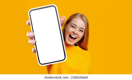 Laughing Young Blonde Woman Showing Mobile Phone With Empty White Screen, Recommending Newest Entertaining Mobile Application, Yellow Studio Background, Mockup, Copy Space, Collage