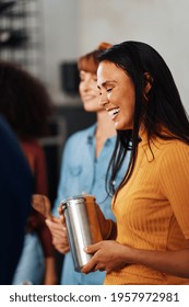 Laughing Young Woman Hanging Out With Her Diverse Group Of Female Friends In An Apartment Kitchen