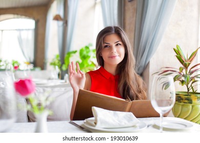 A laughing young woman in a restaurant - Shutterstock ID 193010639