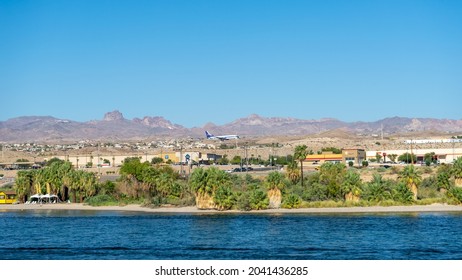 Laughlin, NV, USA – August 27, 2021: A commercial jet airplane flying low for landing at Bullhead City Airport as seen from Laughlin, Nevada.