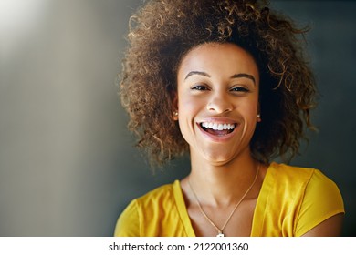 Laughter Is Contagious, Pass It On. Studio Portrait Of A Happy Young Woman Posing Against A Dark Background.