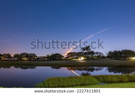 The launch of the Artemis 1 NASA rocket with trajektory reflected in the lake at Boynton Beach, Florida, USA