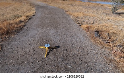 launch pad for a model rocket sits outside on a gravel path - Powered by Shutterstock