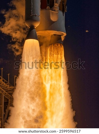 The launch of a space heavy rocket at night. A man in a hard hat stands in front of a large industrial plant. The blast furnace liquid metal. Elements of this image furnished by NASA
