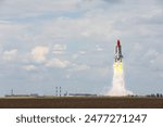Launch of space rocket in field on sunny day