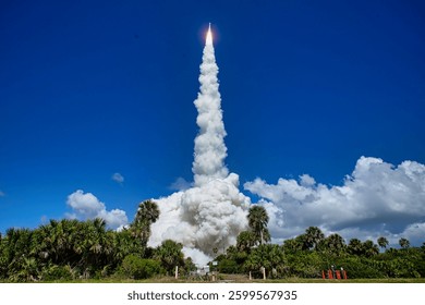Launch of a space shuttle into space. Three rockets launch from a sandy beach under a clear blue sky. Launch of a space rocket into space. Elements of this image furnished by NASA
