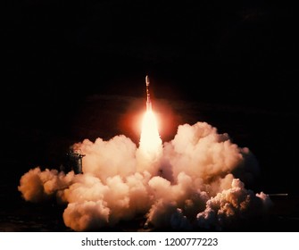 Launch of the spaceship from the spaceport at night. Flight of space shuttle in clouds of smoke. Some elements of this image are furnished by NASA - Powered by Shutterstock