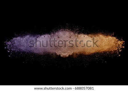Launched colorful dust, isolated on black background
