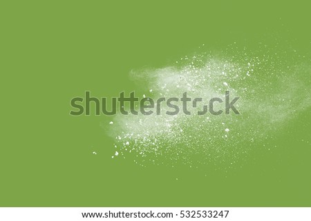 Launched colorful powder, isolated on green background