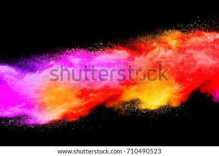 Launched colorful powder on black background or Color powder explosion on black background. Mauve color cloud. color dust explode. Freeze motion paint Holi.