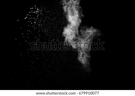 Launched white powder, isolated on black background