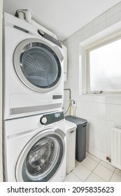 Laundry Area In The Corner Of The Room With Washer And Dryer