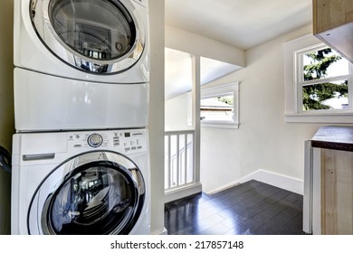 Laundry Area With Modern White Appliances And Window