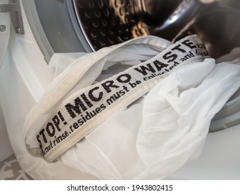 Laundry bag for capturing microplastics released from synthetic textile products. Microfiber pollution. Environmental awareness.