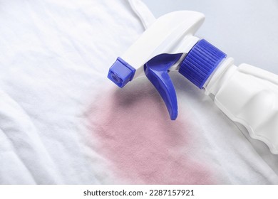 Laundry detergent with stained clothes on light background, closeup - Powered by Shutterstock