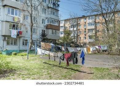 Laundry dries on the rope in courtyard of Khrushchyovka, a common type of old low-cost apartment building in Russia and post-Soviet space. Life in Russia. Russia, Vladivostok.