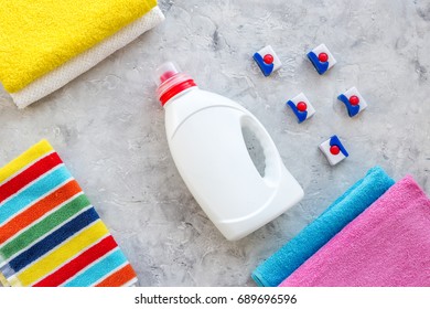 Laundry. Dry and liquid detergents near clean towel on grey stone background top view copyspace - Shutterstock ID 689696596