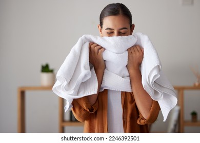 Laundry, fresh and woman smelling a towel after cleaning, housework and washing clothes in the morning. Chores, housekeeping and cleaner with smell of clean clothing after a routine wash at home - Shutterstock ID 2246392501