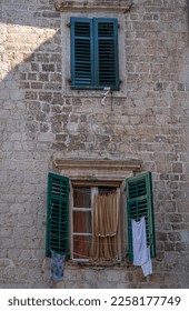 Laundry hanging outside a window in Old Town Kotor, Montenegro - Shutterstock ID 2258177749
