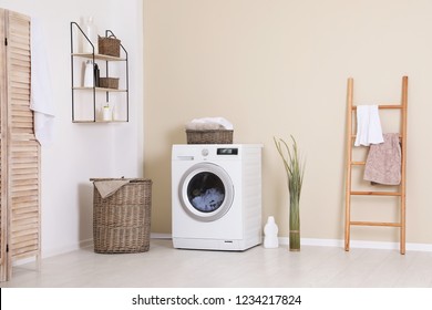 Laundry Room Interior With Washing Machine Near Wall