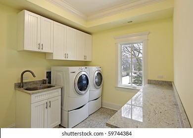 Laundry Room In Luxury Home With Large Washer And Dryer