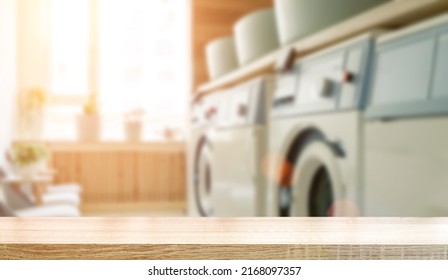Laundry room table background. Blurred home laundry room with wooden table display for product. - Shutterstock ID 2168097357