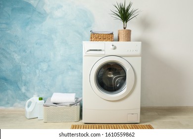 Laundry room with washing machine against light blue wall, space for text - Shutterstock ID 1610559862