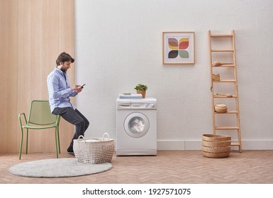 Laundry room washing machine and dirty clothes decorative modern style. Man is waiting for the machine to finish. - Powered by Shutterstock