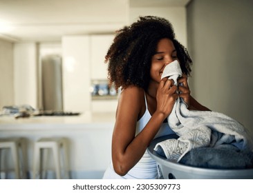 Laundry smell, African woman and home cleaning chores with happiness and calm. Smile, fresh clothes and happy with housekeeping of a black female person in a house feeling relax in the morning - Shutterstock ID 2305309773