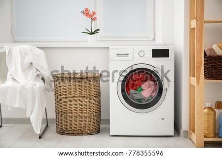 Laundry in washing machine and basket indoors