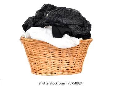 Laundry in a wicker basket, isolated on white