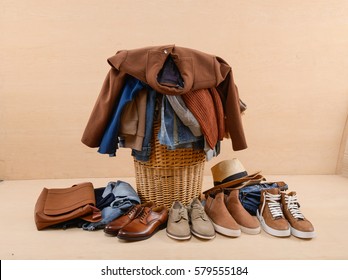 Laundry In A Wicker Basket And Men's Shoes, Clothes Jeans-wooden Background