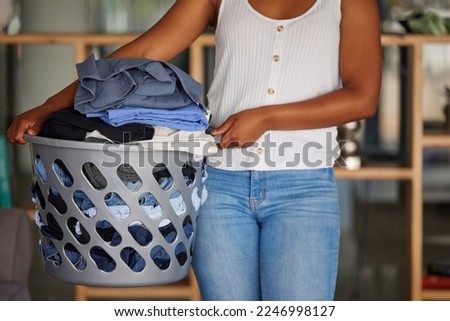 Laundry, woman and holding basket with clean clothes for home housekeeping. Closeup female, clothing fabric and laundry room of spring cleaning service, textile container and maintenance in apartment