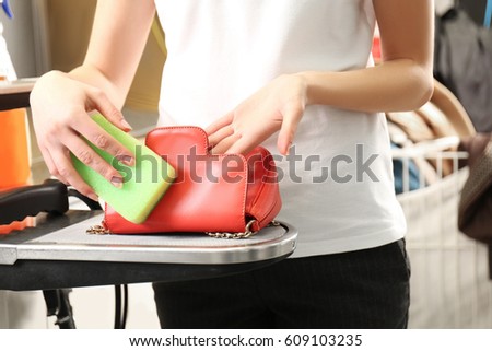 Laundry worker washing little bag at dry-cleaning