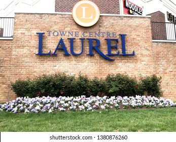 Laurel, Maryland/USA-April 25, 2019: Laurel Towne Center Sign With A Brick Background Decorated With Foliage On The Bottom.