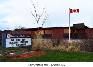 Laurelwood Pubic School The Canadian Flag Front Of The Entrance And A Sign We Miss  You Distance Learning Is Happening In Waterloo Ontario Canada April 16, 2020 