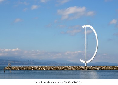 Lausanne, Switzerland - July 29, 2019: Pier and the well known wind vane Eole made by Clelia Bettua in the beautiful port Ouchy at the Lake Geneva