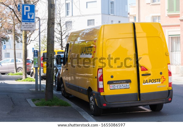 Lausanne, Switzerland - March 25, 2019:a\
van of Swiss Post parked on the Lausanne. Swiss Post is the\
national postal service of Switzerland, being a public company\
owned by the Swiss\
Confederation