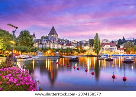 Lausanne, Switzerland from the Ouchy Promenade on Lake Leman at twilight.