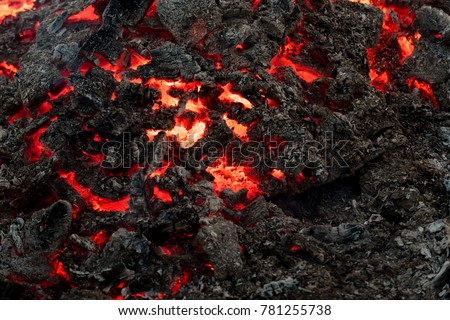 Lava flame on black ash background. Formation, geology, nature, environment. Danger, hazard, energy concept. Volcano, fire, crust. Magma textured molten rock surface.