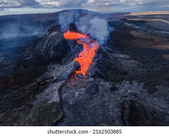 Lava Flow From The Crater Opening Of Fagradalsfjall Volcano. View From Above Into The Volcanic Crater On Iceland In The GeoPark. Daytime Volcanic Eruption On Reykjanes Peninsula