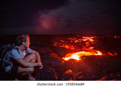 Lava Flow Man Hiker On Night Hike Watching Magma Erupting Flowing From Volcanic Eruption In Kilauea Volcano, Big Island, Hawaii Travel. Long Exposure.