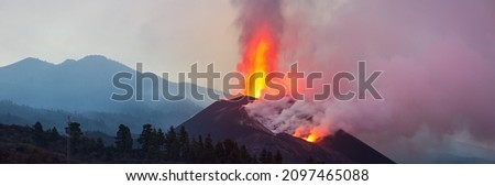 Lava spurts from erupting volcano Cumbre Vieja on the canary island la palma