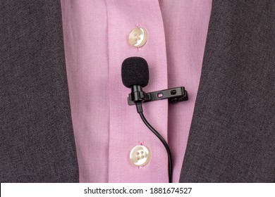 The Lavalier Microphone Is Secured With A Clip On A Women's Shirt Close-up. Audio Recording Of The Sound Of The Voice On A Condenser Microphone